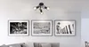 A modern living room with a ceiling light fixture and framed artwork above a sofa. Anteprima dell’immagine prodotto