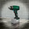 A cordless heat gun with a battery pack is displayed on a textured surface in front of a brick wall. Produktbild-Vorschau