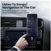 A hand is shown plugging an aux cable into a smartphone, which is mounted in a car's dashboard. The phone screen displays a music app. Anteprima dell’immagine prodotto