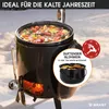 A black outdoor stove with a pot of food on top, set in a snowy environment. Produktbild-Vorschau