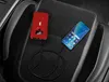 A red power bank is connected to a smartphone, both resting on a car seat. Anteprima dell’immagine prodotto