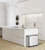 A modern, minimalist kitchen with a stainless steel trash can. Podgląd zdjęcia produktu