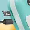 A close-up view of a teal and white device, showing a micro SD card being inserted and a USB cable plugged into a port. Náhľad obrázku produktu