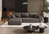 A modern living room with a fireplace, a sectional sofa, and coffee tables. Náhled obrázku produktu