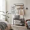 A bedroom scene featuring a coat rack with clothes and accessories, a bed, and a plant. Produktbild-Vorschau