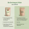A comparison of two pouches of barley grass powder, one from Achterhof and another generic one labeled 'Andere'. The Achterhof product is highlighted with positive attributes, while the generic one has negative comparisons. Produktbild-Vorschau
