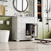 A bathroom vanity with drawers and an open cabinet, a toilet, and a shower in the background. Podgląd zdjęcia produktu
