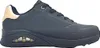 A side view of a black Skechers women's sports shoe with gold accents on the heel. Voir les images du produit