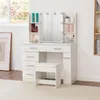 A white vanity table with a mirror, lights, drawers, and shelves, along with a matching stool, is shown in a well-lit room. Produktbild-Vorschau