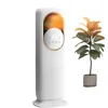 A white electric heater and a potted plant against a white background. Podgląd zdjęcia produktu