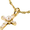 A close-up shot of a gold cross pendant with a pearl and clear stones, attached to a gold chain. Voir les images du produit