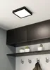A modern hallway or entryway with a ceiling light, cabinets, shelves, and hooks. Produktbild-Vorschau