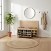 A hallway or entryway with a shoe cabinet, plant, and round rug. Produktbild-Vorschau
