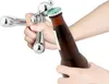 A hand is using a bottle opener to open a brown glass bottle. Náhľad obrázku produktu