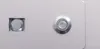 A close-up view of two metal components on a light-colored surface. Náhled obrázku produktu