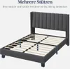 A dark gray upholstered bed frame with wooden slats is shown from a slightly elevated side angle against a white background. Podgląd zdjęcia produktu