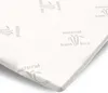 A close-up, angled view of a white mattress topper with embossed text and graphics. Náhled obrázku produktu