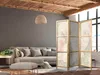 A living room with a sofa, ottoman, and a room divider. Anteprima dell’immagine prodotto
