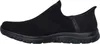 A side view of a black Skechers slip-on sneaker. Voir les images du produit