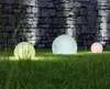 Three illuminated spheres are placed on a grassy lawn in front of a stone wall. Anteprima dell’immagine prodotto