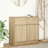 A wooden sideboard with two drawers and two doors, placed in a room with a plant and a coat rack.