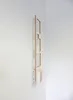 A wooden shelf mounted on a white wall. Produktbild-Vorschau