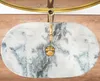 A top-down view of a marble sink with a gold faucet. Anteprima dell’immagine prodotto