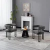 Two modern chairs and a coffee table are arranged in a living room setting with a fireplace and a plant. Produktbild-Vorschau