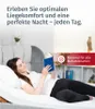 A woman is lying on a bed reading a book, with text overlays promoting comfort and mattress compatibility. Produktbild-Vorschau