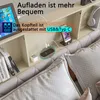 A close-up view of a bed headboard with integrated charging features. Produktbild-Vorschau