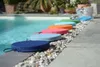 A row of colorful round cushions are placed on the edge of a swimming pool. Produktbild-Vorschau