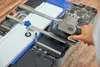 A person is using a DREMEL Blueprint Mobile Saw Station to cut a white piece of trim. Produktbild-Vorschau