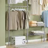 SoBuy Garderobenständer KLS04-HG: Beige T-Shirts und Stauraumbox im Vordergrund vor grüner Wand Produktbild-Vorschau