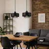 A dining area with a wooden table and chairs, a sofa, and pendant lights. Náhled obrázku produktu