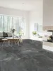 A modern living room with a large window, sofa, coffee table, and fireplace, showcasing the flooring. Produktbild-Vorschau