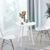 A white round dining table with two chairs in a bright room with sheer curtains. Produktbild-Vorschau