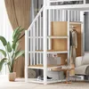 A loft bed with stairs and storage, featuring clothes hanging on a rack and a sofa in the background. Podgląd zdjęcia produktu