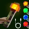 A hand holding a Minecraft-style torch lamp, with other colored torch lamps and a USB cable shown. Náhled obrázku produktu