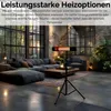 A modern living room with a large sectional sofa, coffee table, and a heater on a tripod stand. Produktbild-Vorschau