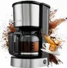A coffee maker with coffee splashing around it and a cup with text. Anteprima dell’immagine prodotto