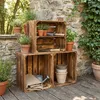 Wooden crates used for displaying potted plants and gardening tools in an outdoor setting. Náhled obrázku produktu