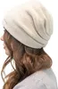 A woman wearing a cream-colored beanie. Produktbild-Vorschau