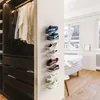 Shoes are displayed on a wall in a closet and a bedroom. Produktbild-Vorschau