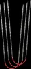 A set of knitting needles with red cords against a black background. Produktbild-Vorschau
