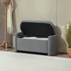 A storage bench with its lid open, revealing white cushions inside, is placed in a room with a coat rack and a plant. Anteprima dell’immagine prodotto