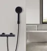 A black shower fixture and bathtub in a modern bathroom. Produktbild-Vorschau