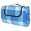 A folded picnic blanket with a blue and white plaid pattern. Produktbild-Vorschau