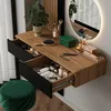 A vanity table with makeup and accessories, set up in a room with a window and a stool. Produktbild-Vorschau