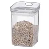 A clear, studio shot of a transparent plastic food storage container filled with sunflower seeds, set against a white background. Voir les images du produit