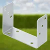 A metal U-shaped bracket is shown against a blurred background of green foliage and a blue sky. Podgląd zdjęcia produktu